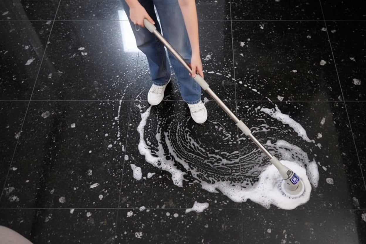 Person cleaning a wooden floor with a mop.