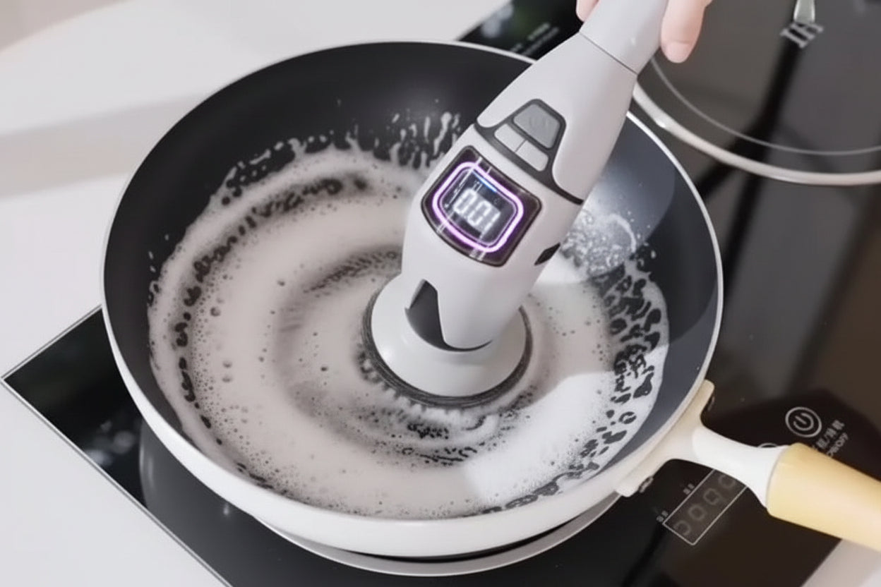 Cleaning a frying pan with a handheld cleaning brush on a stovetop.
